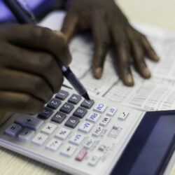 African businessman busy with his calculations. Cape Town, Western Cape, South Africa